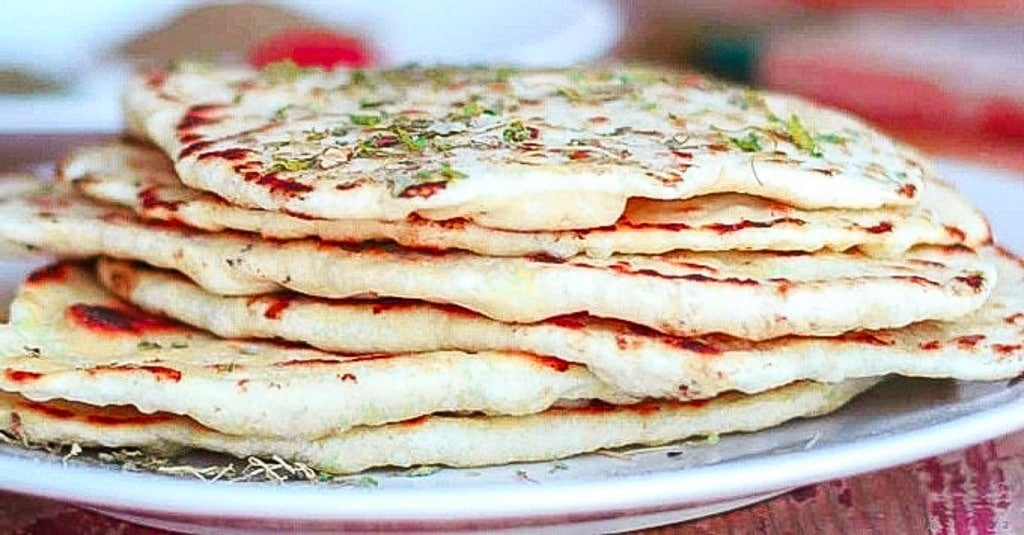 picture of side view of stack of naan on a plate