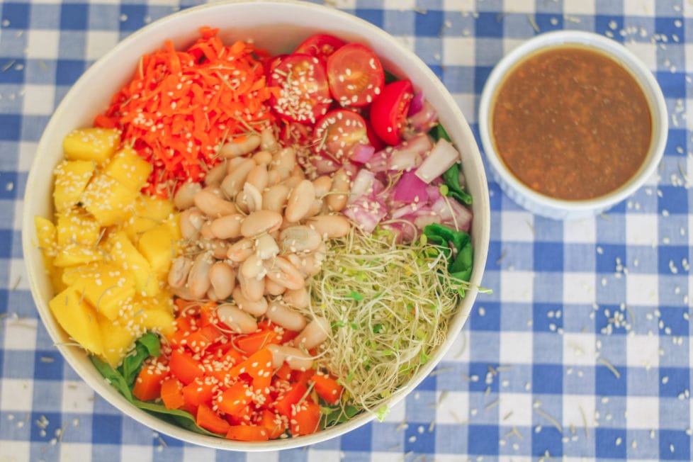 An overhead shot of salad in a white bowl