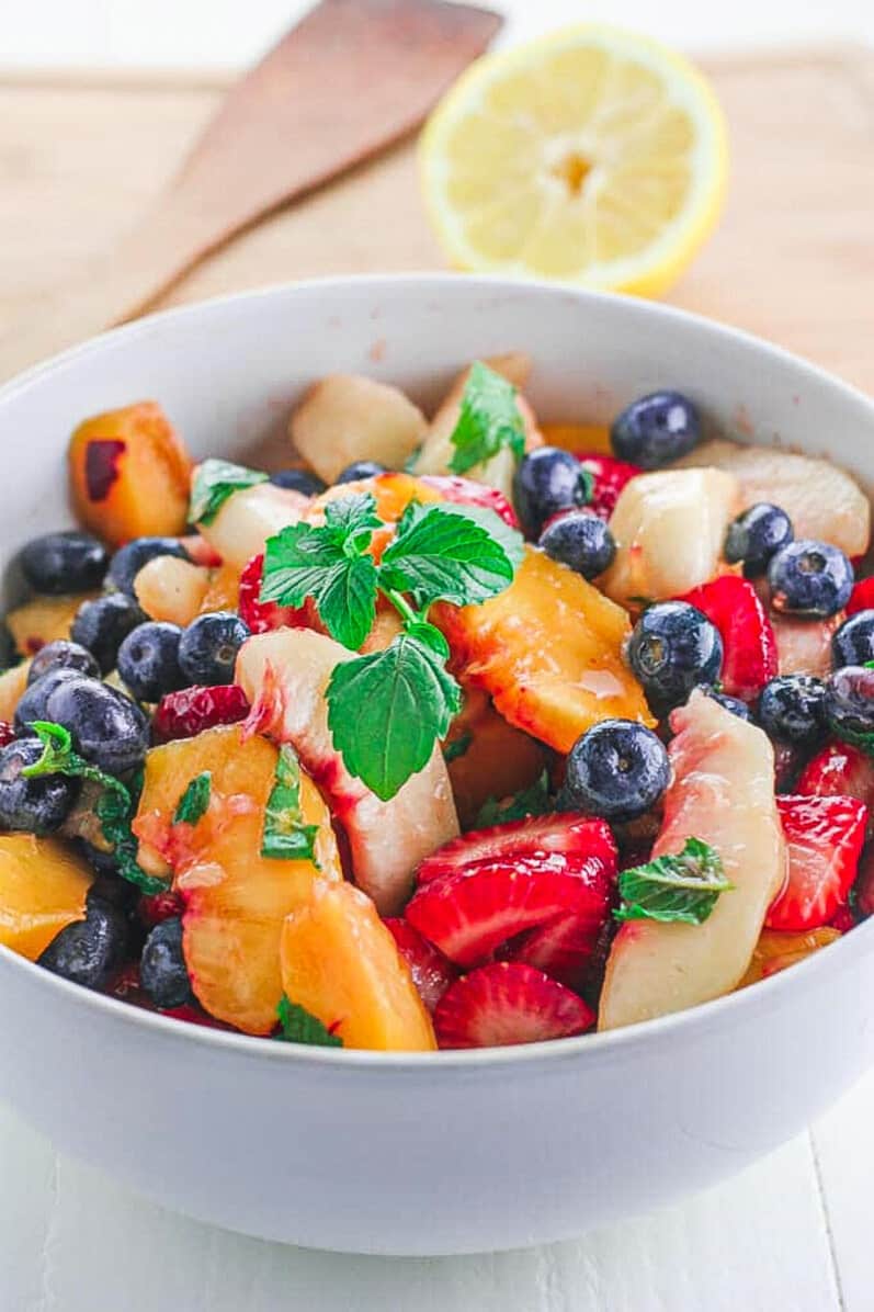 side view of fruit salad with basil 