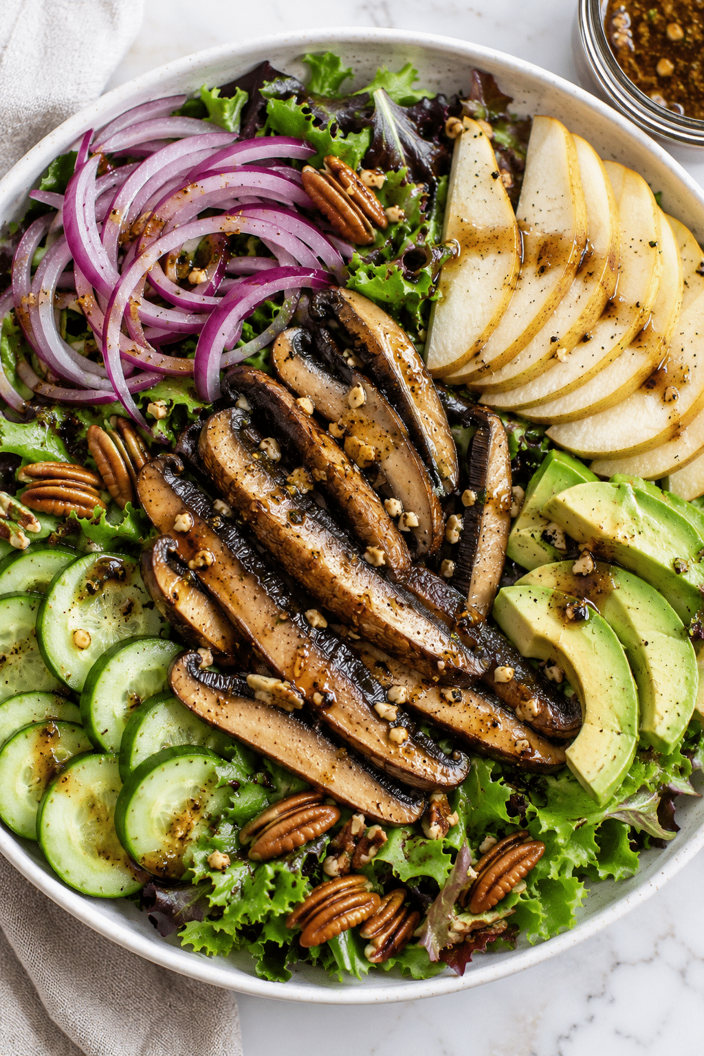 overhead view of portobello mushroom salad in a white bowl