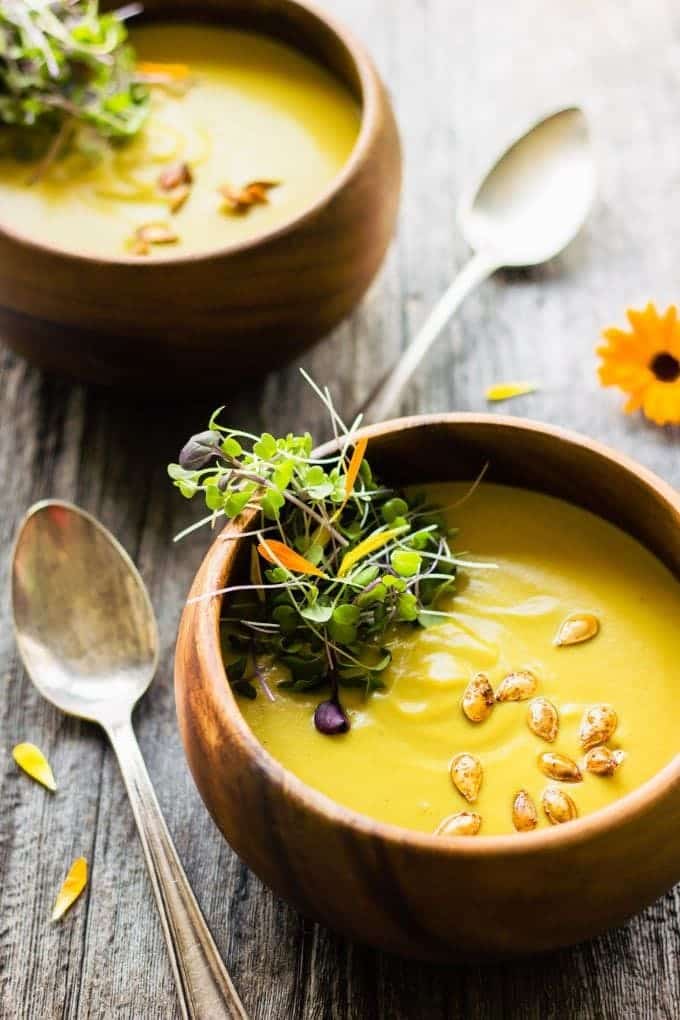 2 bowls of Acorn Squash Soup on a wood table