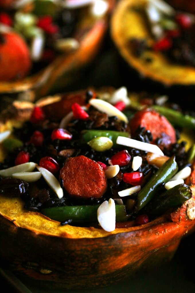 A close up of  an acorn squash stuffed with delightful ingredients