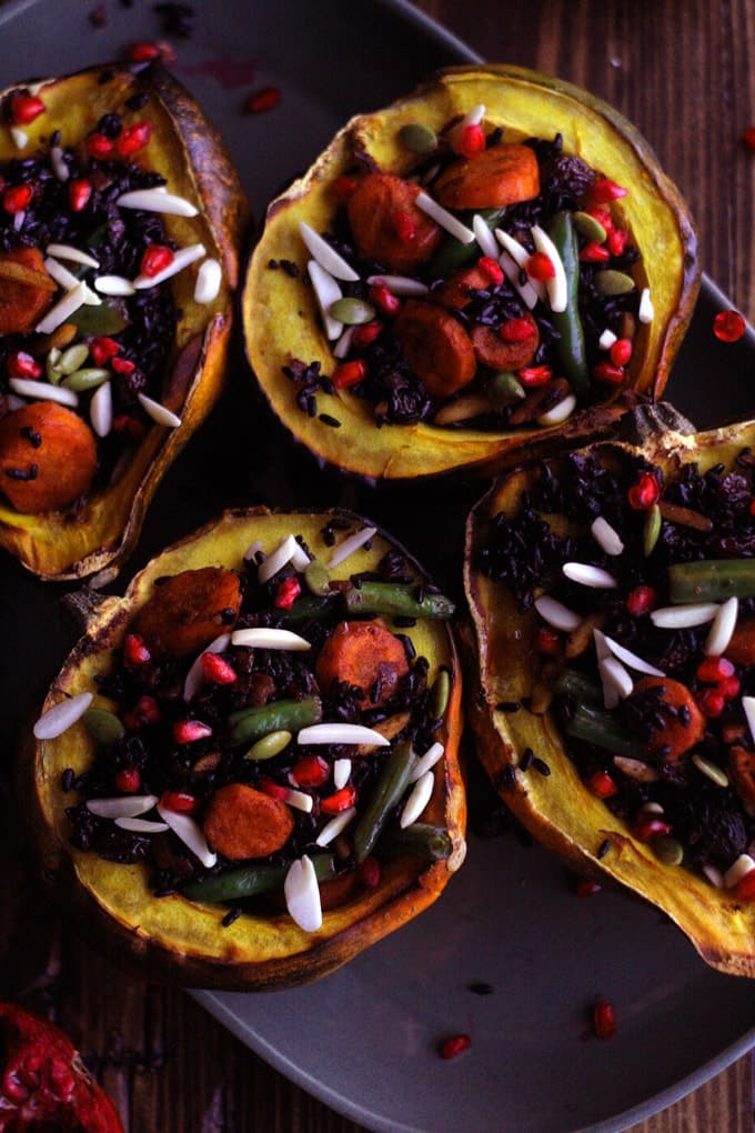 An overhead shot of 4 stuffed acorn squash