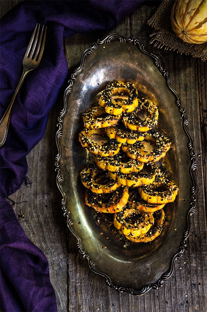 Delicata Squash in a silver serving dish on a dark table