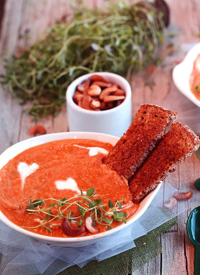 Carrot Bisque in a white bowl topped with creamy hearts