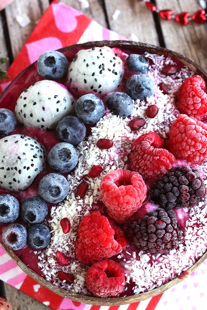 A close up berries and dragonfruit on top of smoothie