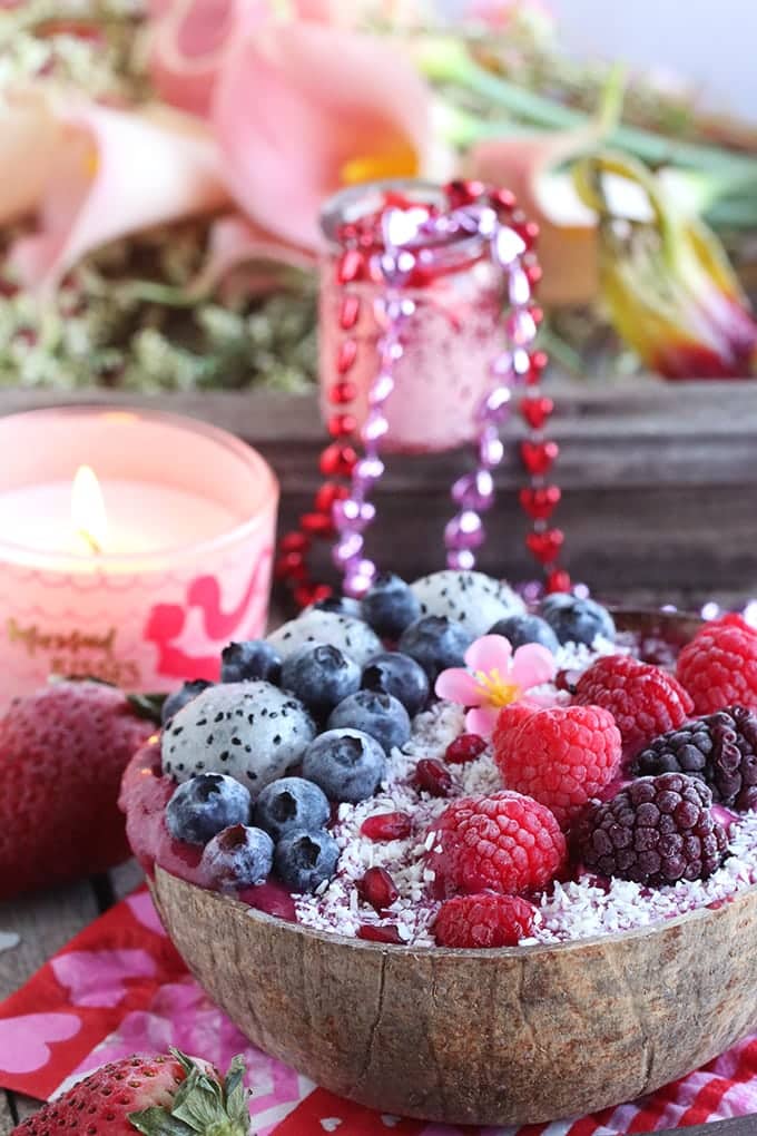 A close up of smoothie bowl topped with berries