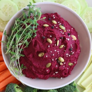 Roasted Beet Hummus in Beige Bowl with Assorted Vegetables