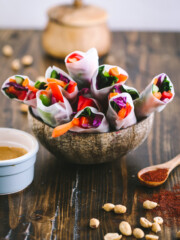Picture of vegan spring rolls in coconut bowl on wooden table