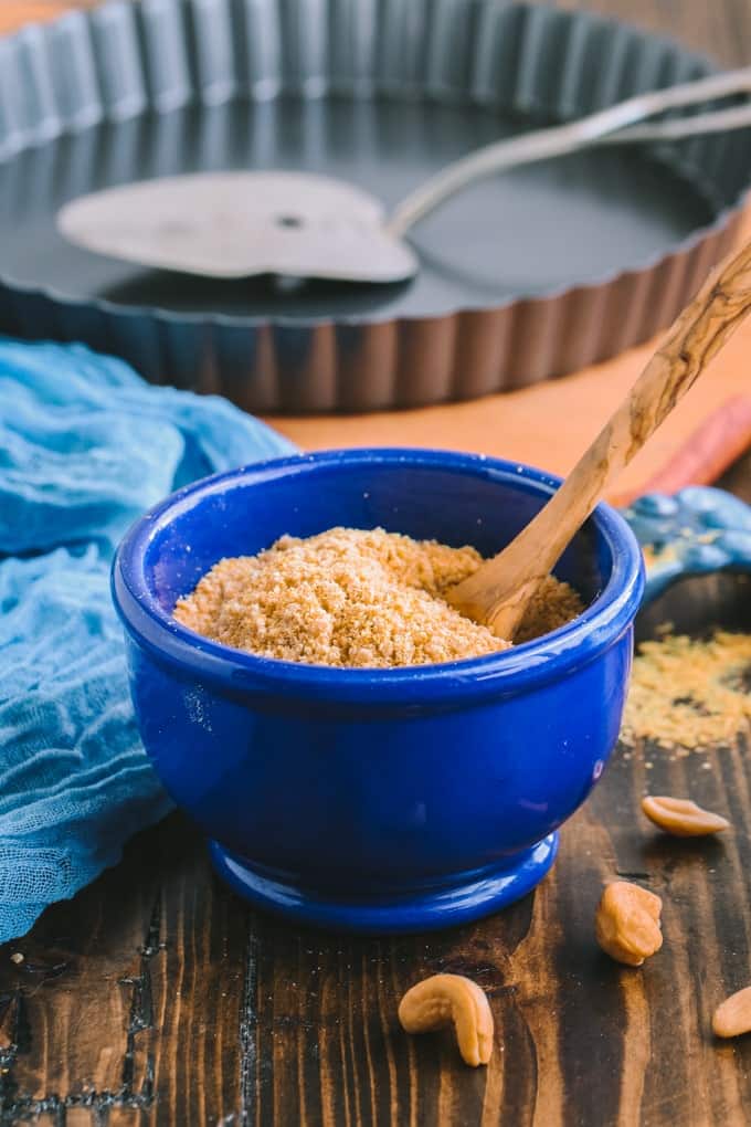 A blue bowl of vegan parmesan cheese