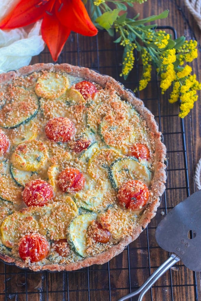 an overhead shot of tart on a cooling rack on wooden table