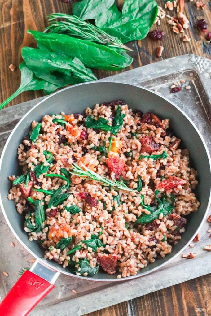 A skillet of food, with Farro and Spinach
