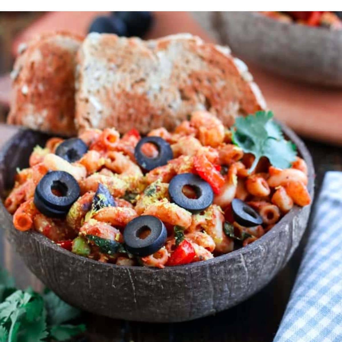 tomato mac and cheese in a coconut bowl