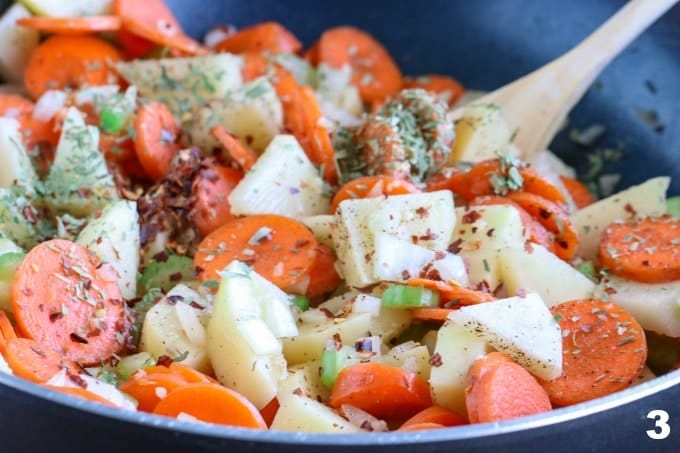 A close up of a skillet of ingredients for Corn chowder 