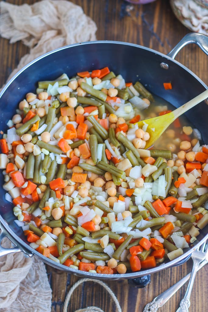 pot pie ingredients such as vegetables and chickpeas added to a wok