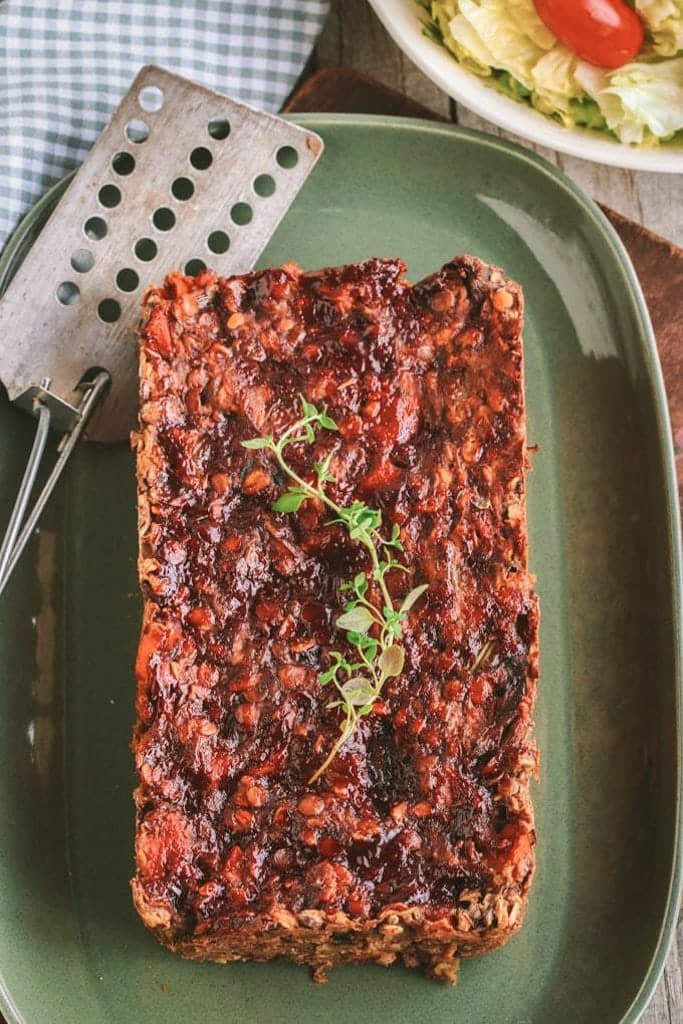 A plate of lentil loaf with rosemary on top