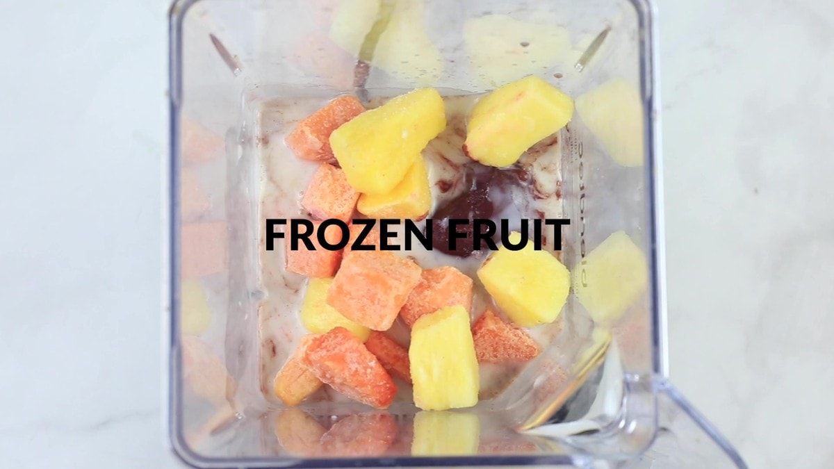 frozen fruit added to blender to make smoothie bowl