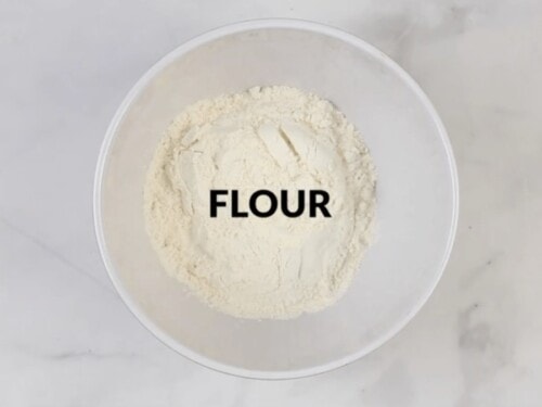 bowl of flour on a white table