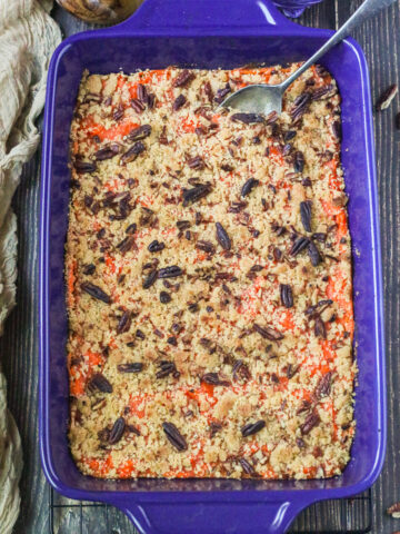vegan sweet potato casserole in a blue dish on a wooden table