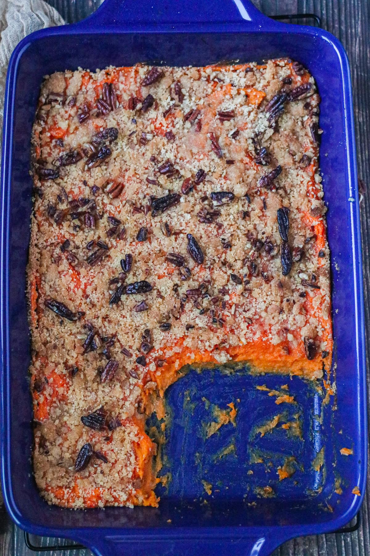 casserole with a couple of servings taken out of blue bowl
