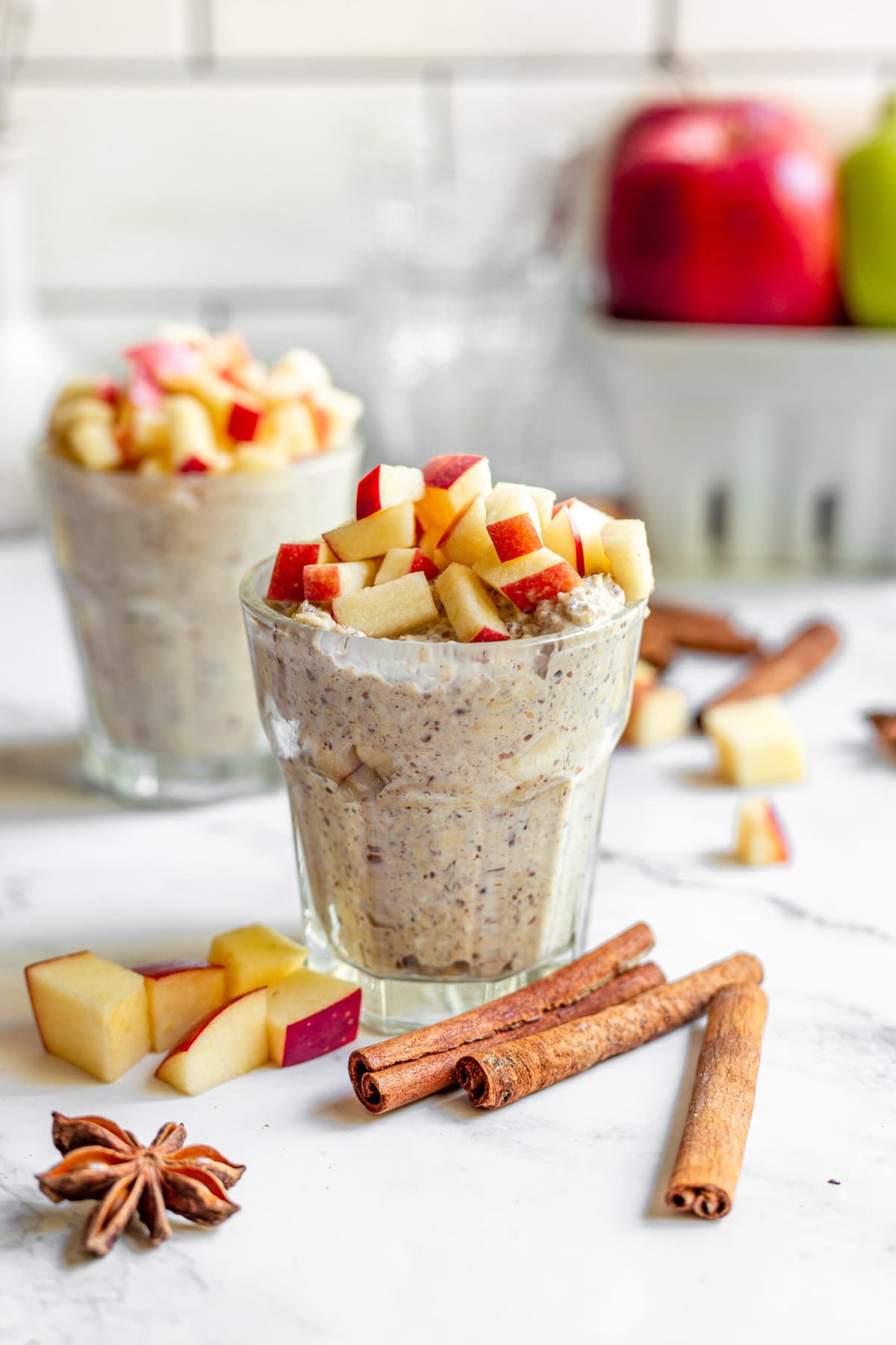 overnight oats in glasses topped with fresh apples