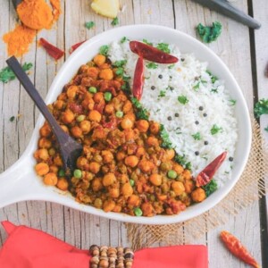 chickpea coconut curry in a white bowl on a wooden table