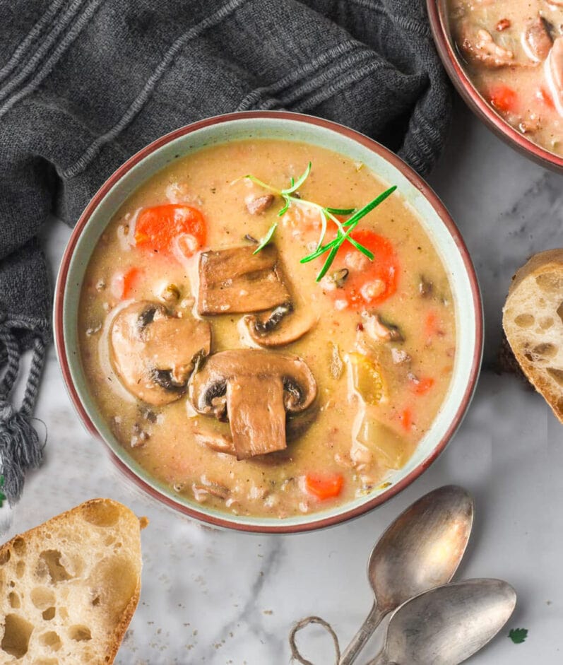 wild rice mushroom soup in a bowl on a marble table