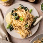 overhead shot of cavolo nero pasta without tomato sauce on a beige table