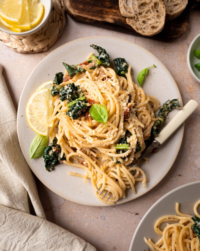 overhead shot of cavolo nero pasta without tomato sauce on a beige table