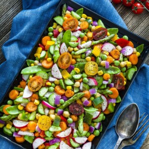 chopped vegetable salad in a baking sheet on a gray table