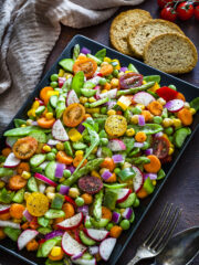 chopped vegetable salad in baking sheet on a gray table