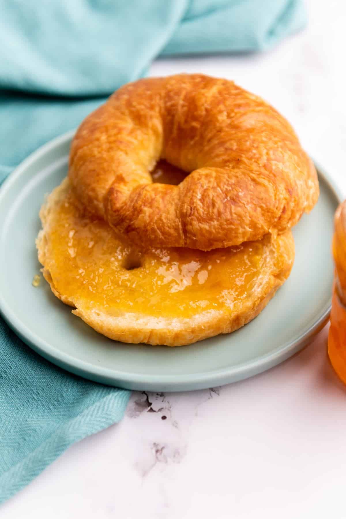 a croissant on a white plate filled with pear ginger jam