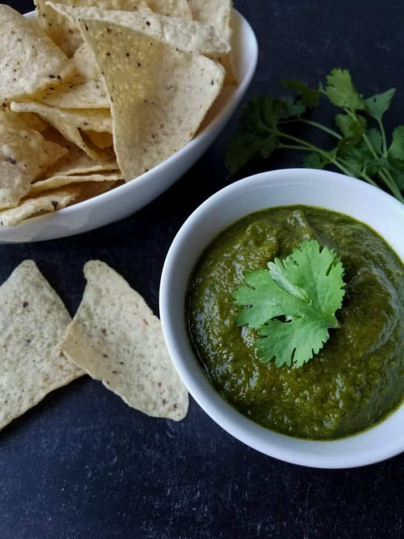 bowl of roasted poblano salsa on a dark blue table