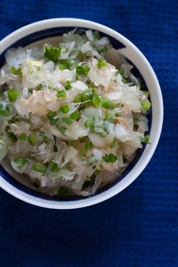 citrus salsa with jalapeño on a blue tablecloth