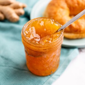 jar of jam on a white table with a green napkin