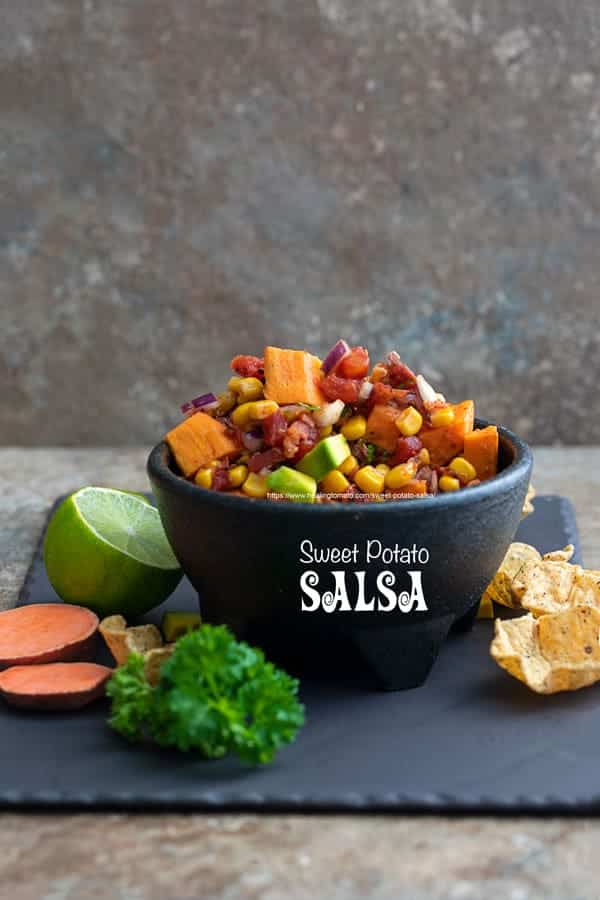 bowl of sweet potato salsa on a cement table 