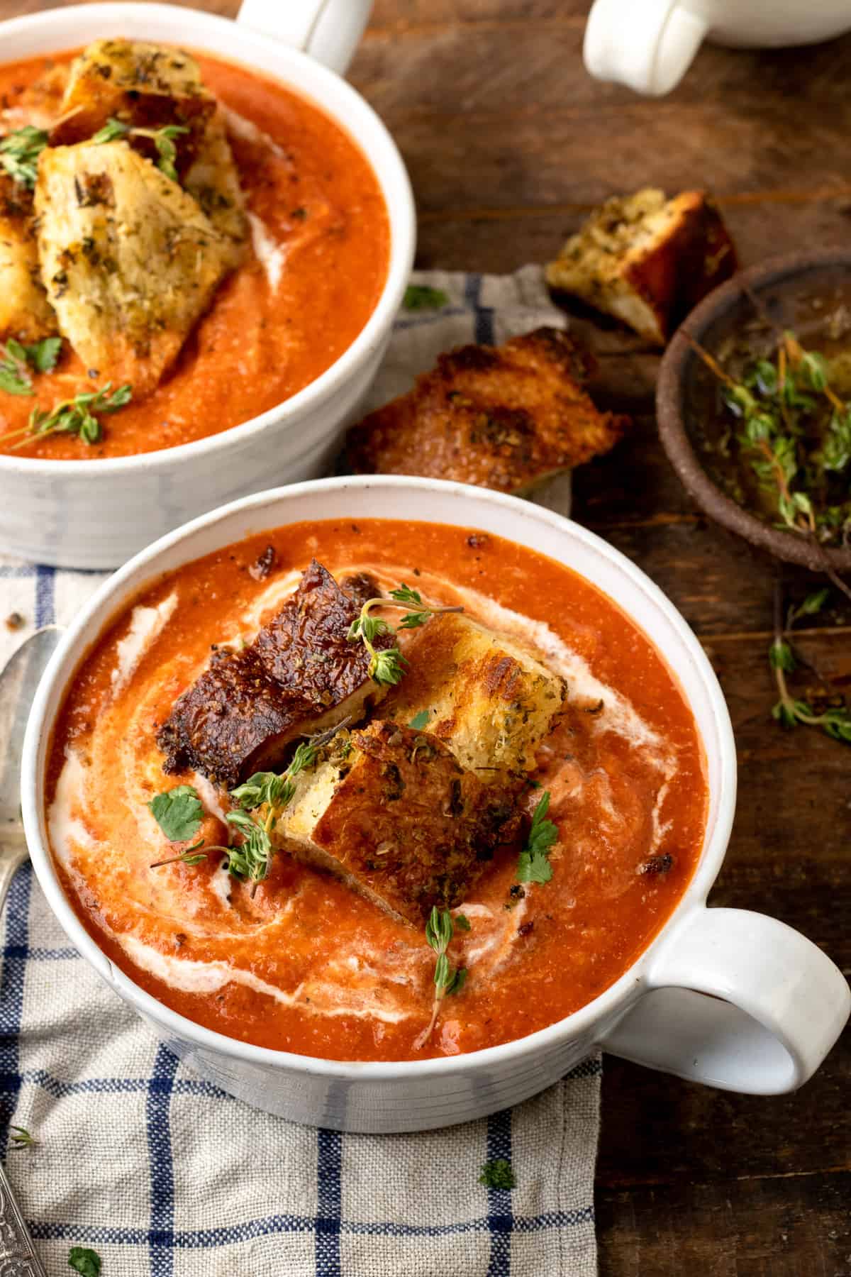 tomato soup in a white bowl topped with croutons