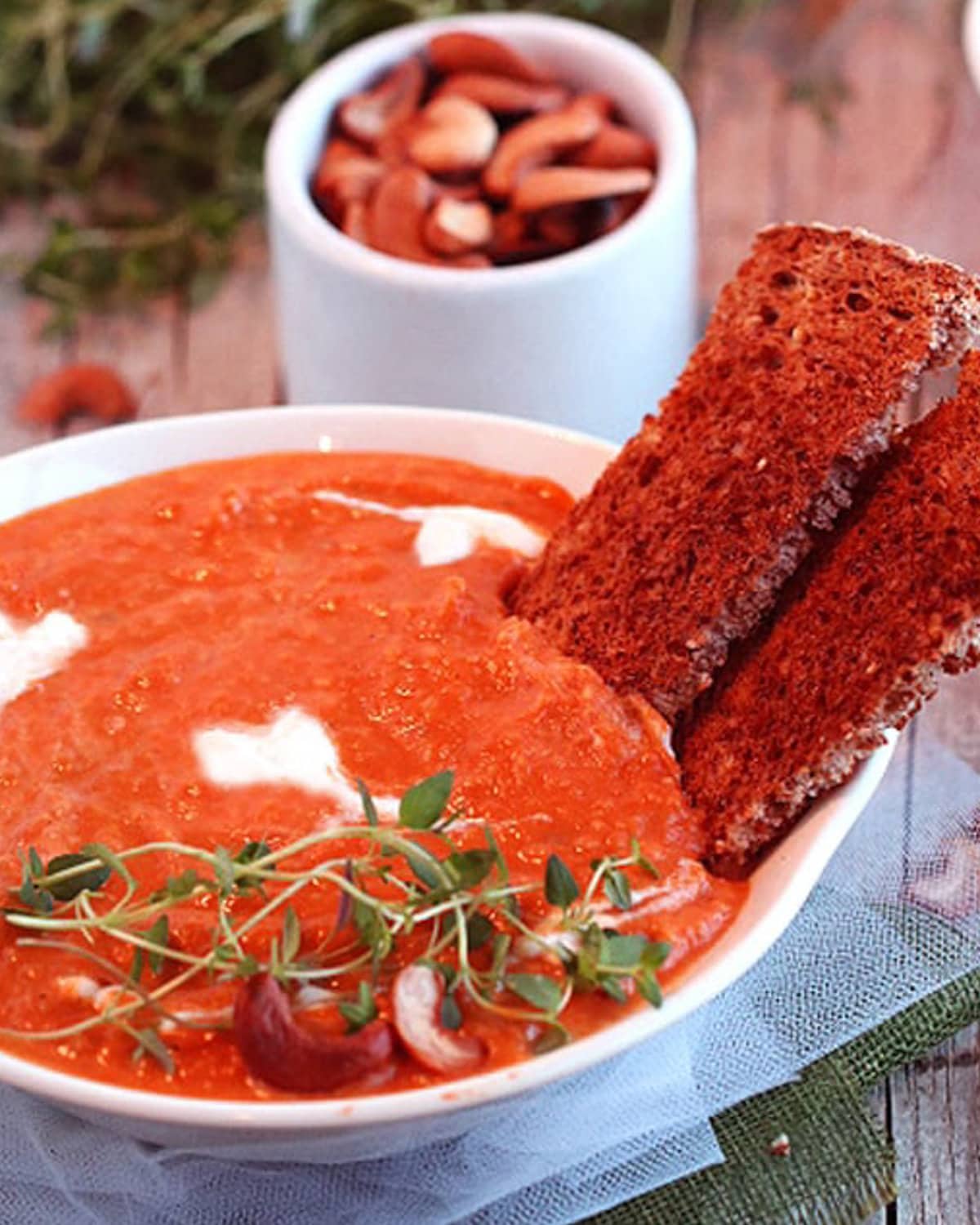 red soup with hearts on it topped with cashews