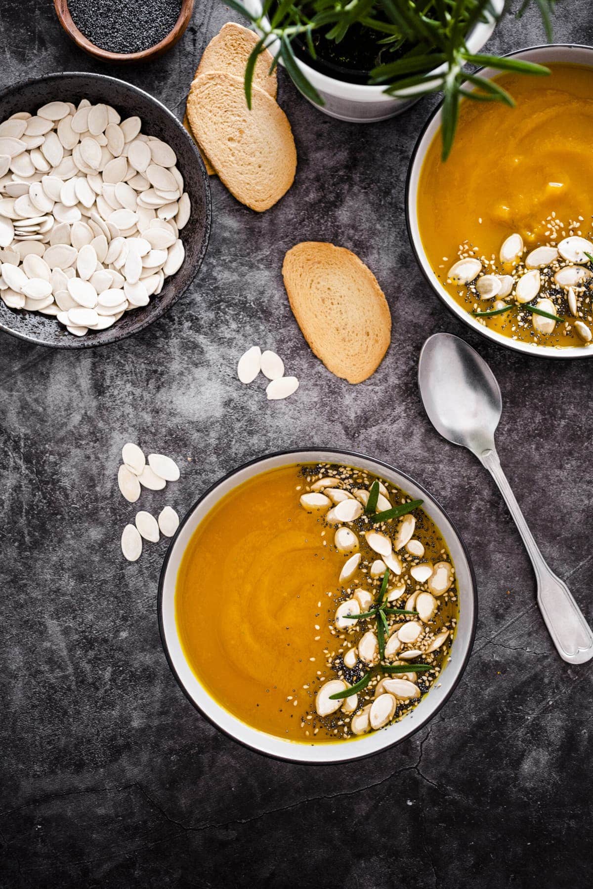 2 bowls of creamy chickpea soup on a grey table