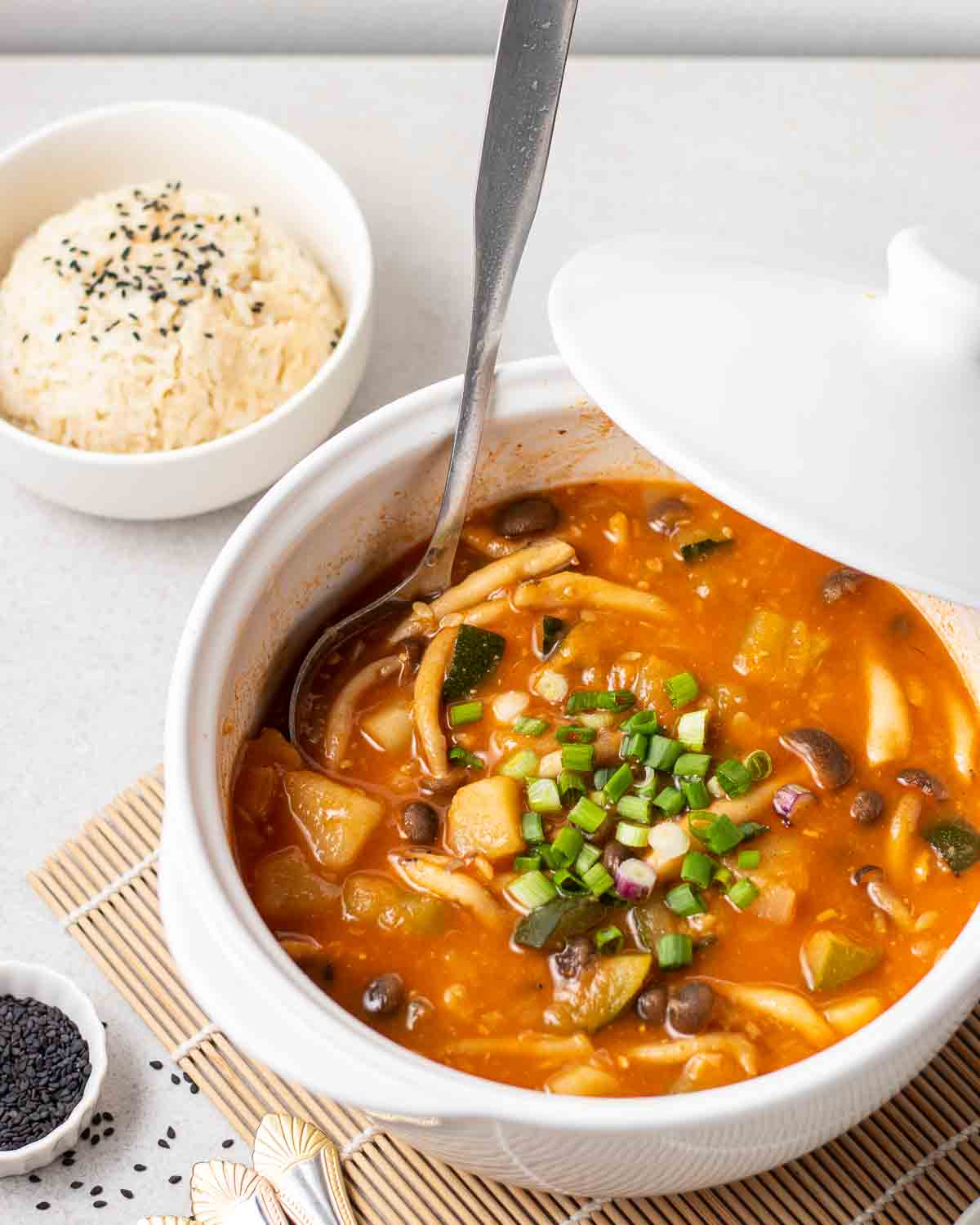 pot of Korean Gochujang soup on a white table with a side of rice