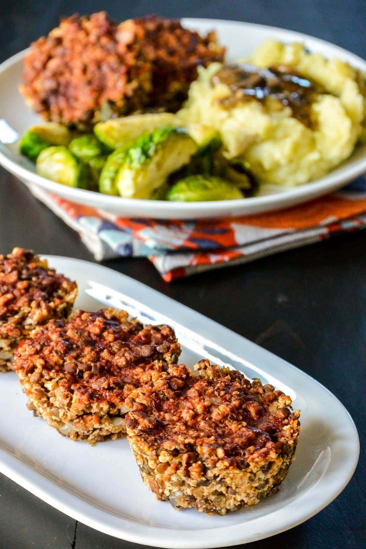 3 lentil meatloaf muffins on a white serving platter