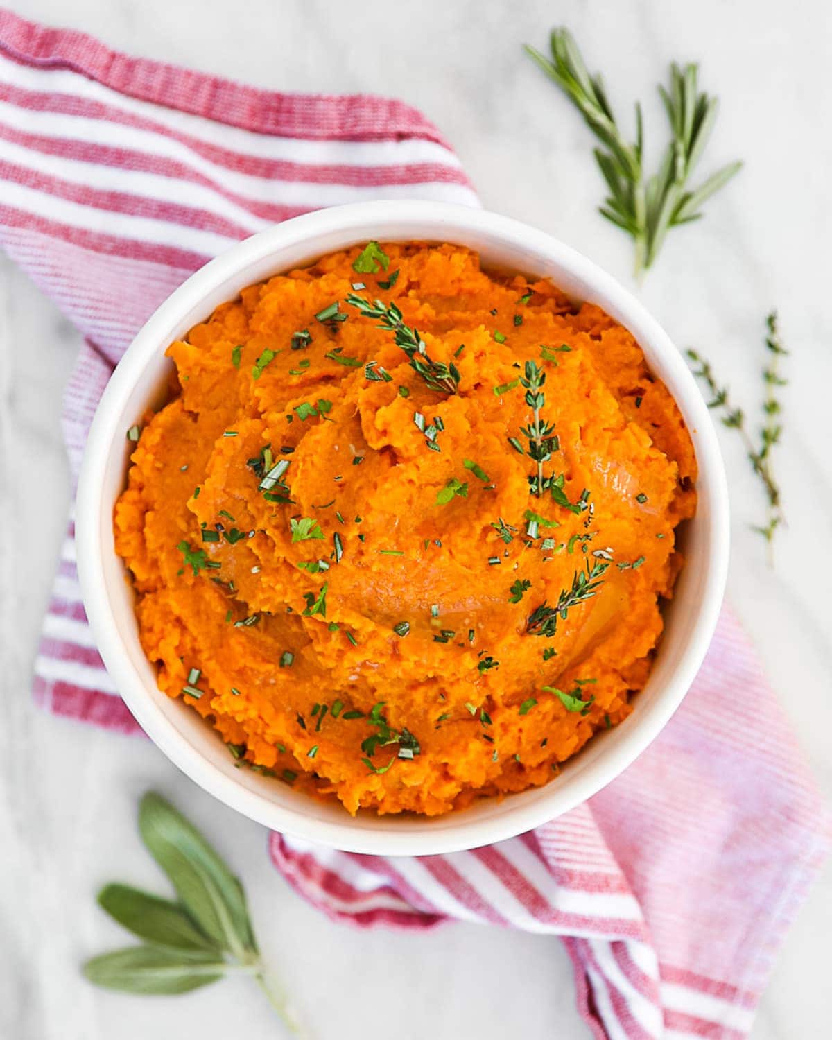 mashed sweet potatoes in a white bowl on a table