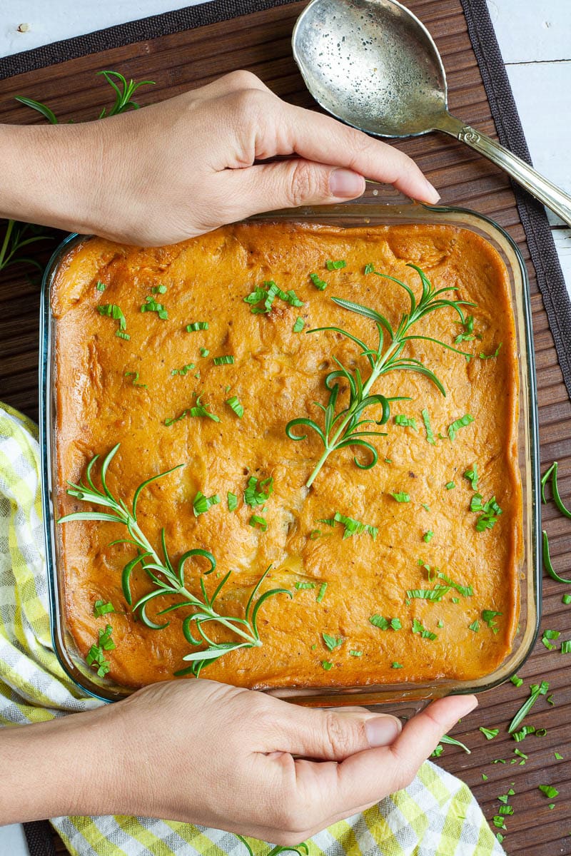 a square casserole dish filled with vegan scalloped potatoes