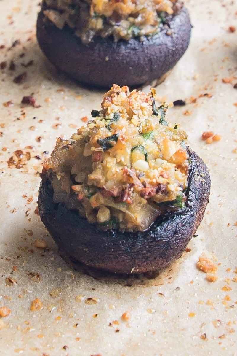 close up of vegan stuffed mushrooms o a sheet pan