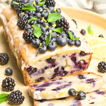 lemon blueberry loaf on an off white plate