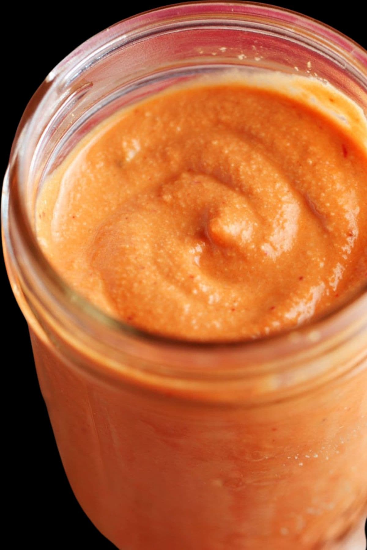 closeup of orange sauce in a jar