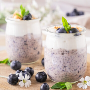 2 jars of blue and white chia pudding on a wooden block