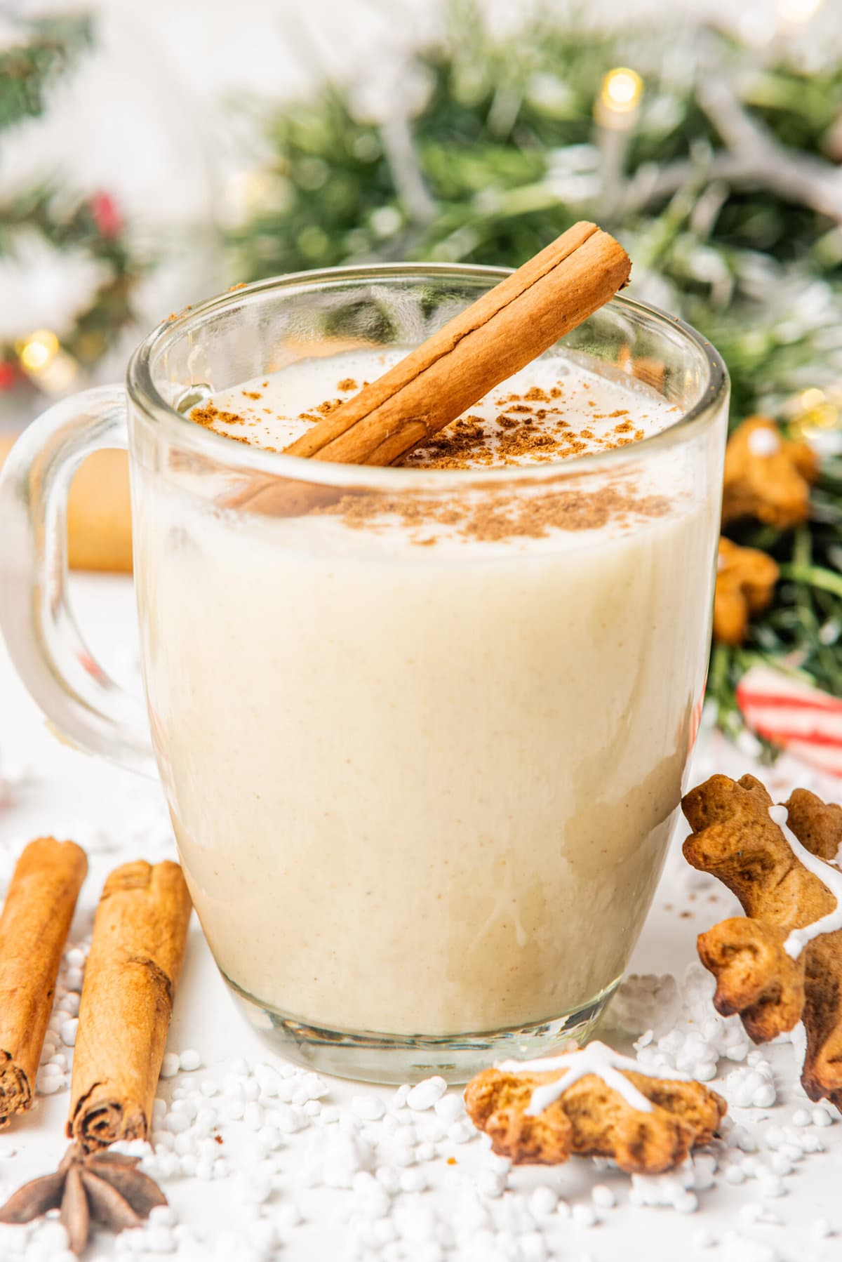 vegan eggnog in a clear glass on a white table
