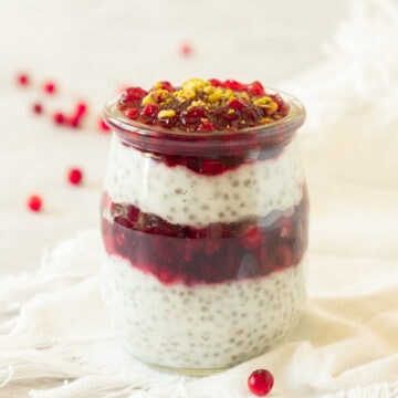 jar of cranberry chia pudding on a white background