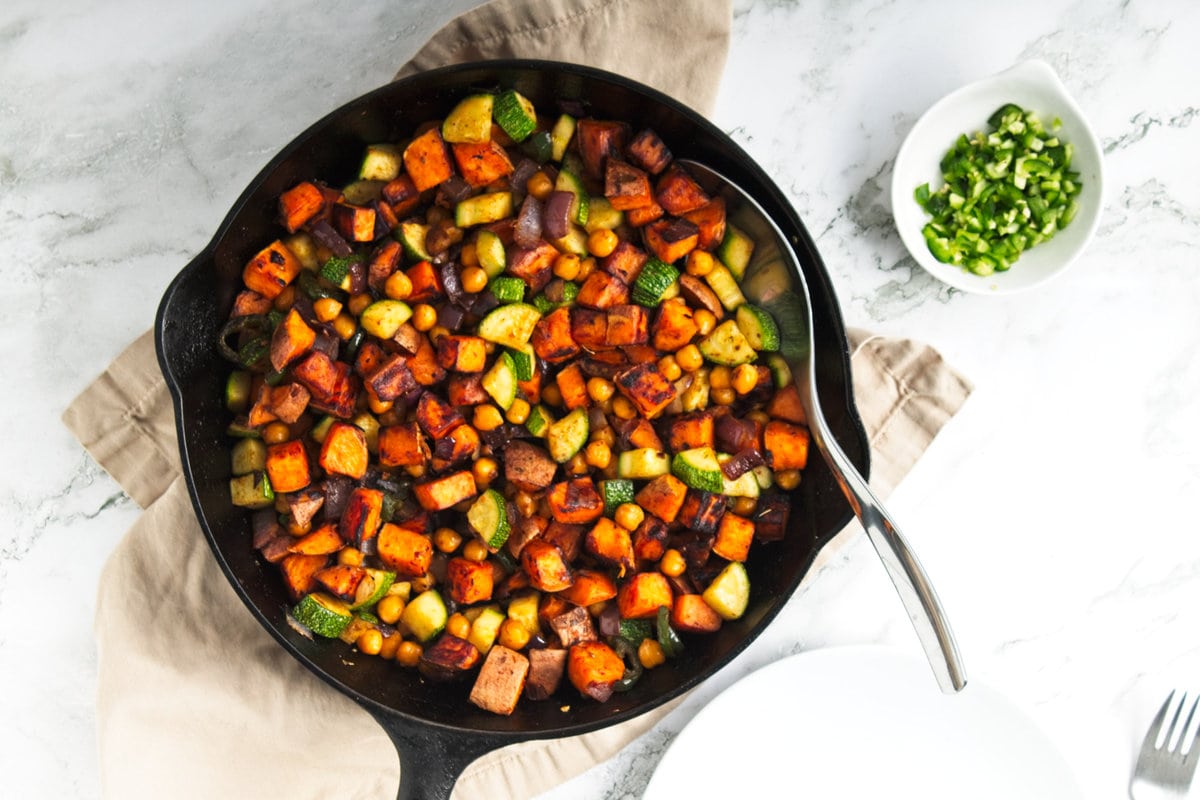 overhead view of sweet potato and veggies in a skillet